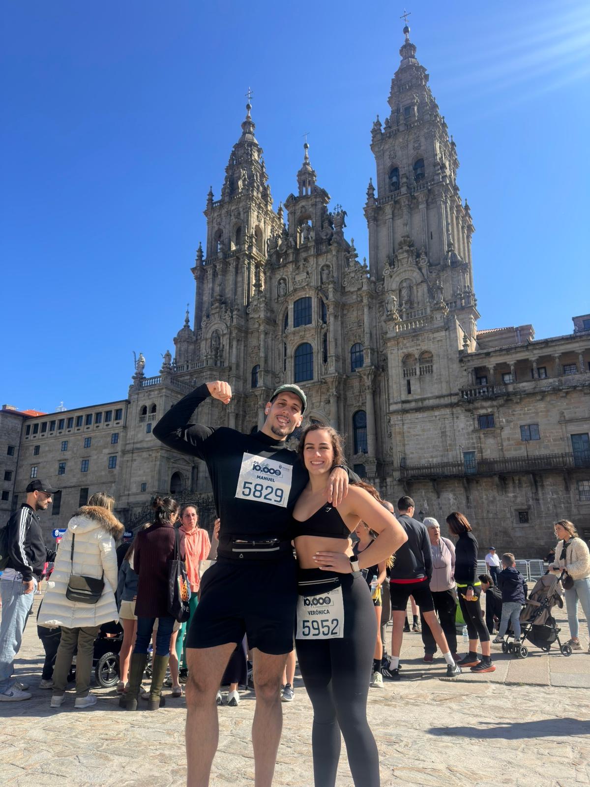 Manu y una compañera después de una carrera, delante de la catedral de Santiago